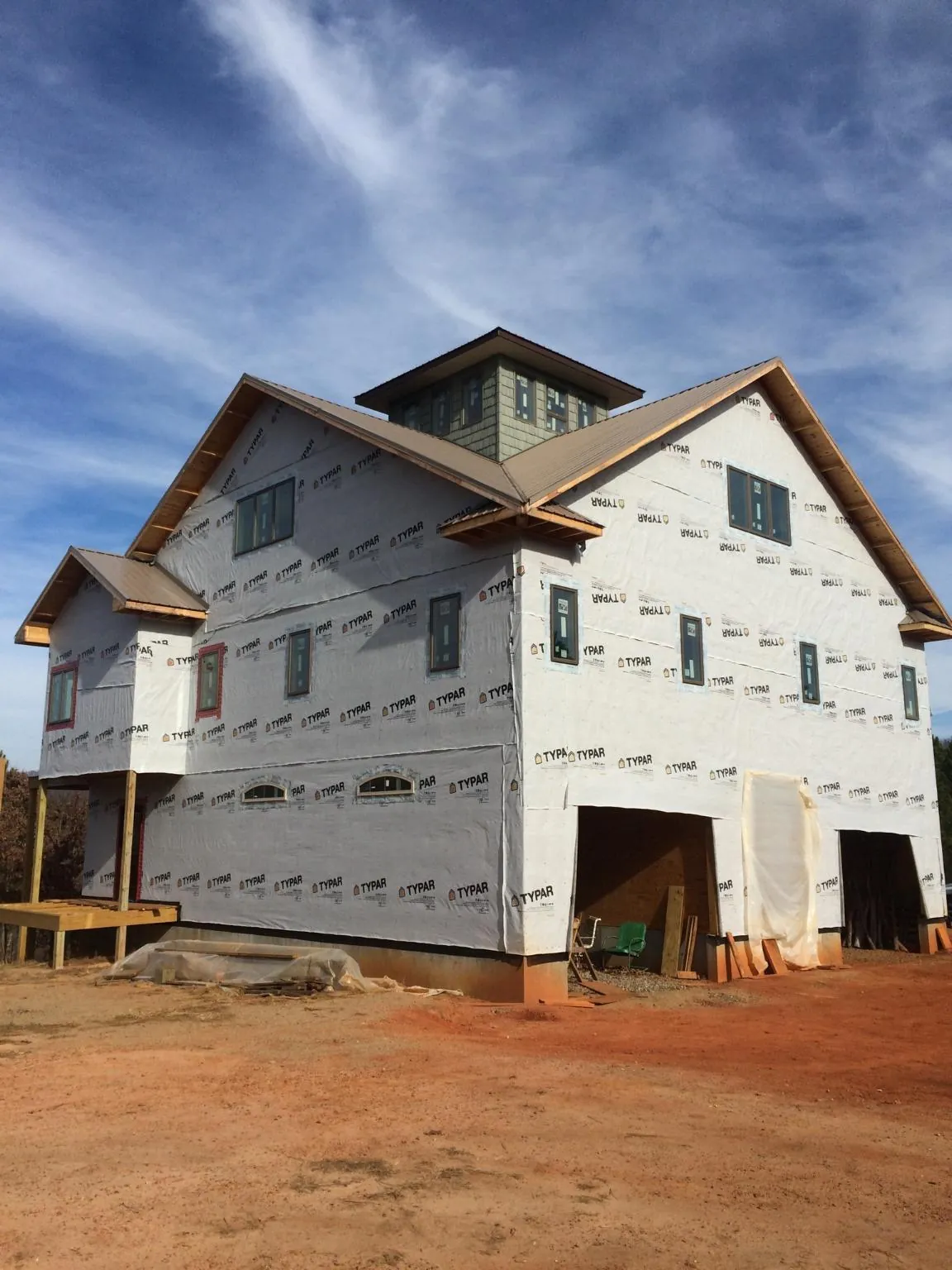 New two story house under construction with a cupola and gabled roofs in Chesterfield
